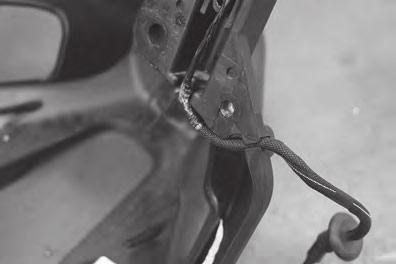 6 Figure 6 Pull wiring out of slot in tire carrier.