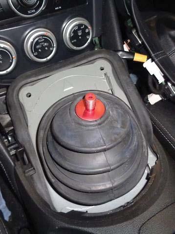 Push the inner dust boot down over the shift lever and re attach it to the