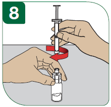 2 - Ta av snäpplocket från injektionsflaskan med Extavia. Det är bäst att använda tummen och inte nageln, eftersom nageln kan brytas av. Ställ injektionsflaskan på bordet.