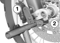 z Underhåll Ställ in kedjans nedhängning ( 81). Framhjulsstöd Montering av framhjulsstöd BMW Motorrad-framhjulsstödet är inte konstruerat för att hålla motorcyklar utan hjälpstöd.