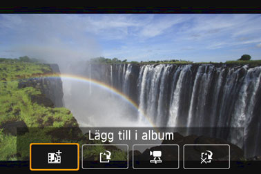 Välj [J Lägg till i album] och tryck sedan på <0>. Om du vill skapa ytterligare ett album med video-snapshot väljer du [W Spara som nytt album].