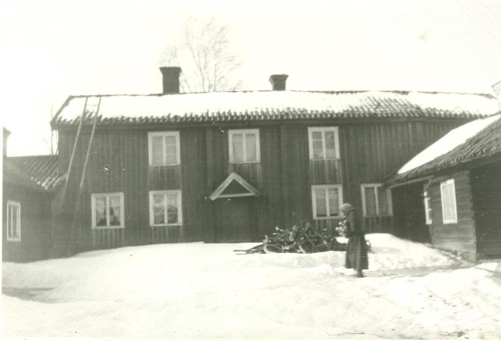 PM 6 (10) Bilden på Lars Ors-Kari som hämtar ved togs strax före hennes död 1940. Hon bodde ensam på gården under många år och behöll husen i oförändrat skick.