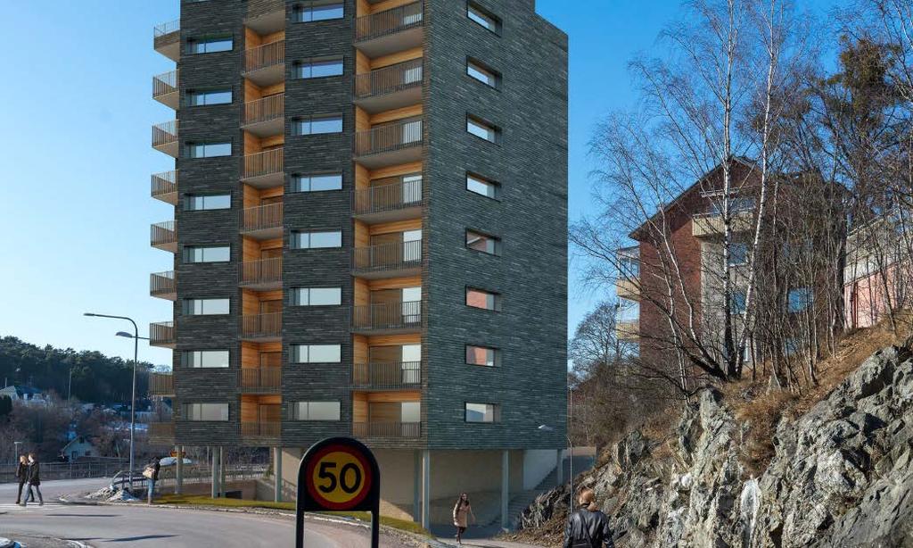 På byggnadens andra sida, mot gatukorsningen, öppnar sig byggnadsvolymen i bottenvåningen och tar hänsyn till befintlig gång- och cykelväg som delvis dras genom huset.