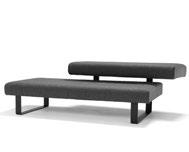 The sofa have 2 seats and the high one is also a backrest. Frame in steel in standard (black), or. Seat with wood base and cold foam upholstered in standard or c.o.m. Upholstery with pattern stiching.