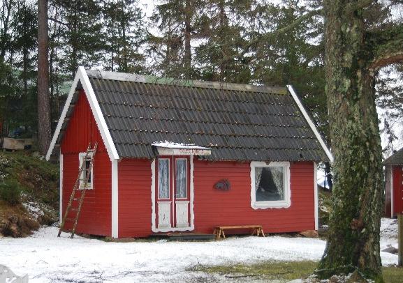 bevarade äldre fritidshus. Många av husen har röda träfasader med vita detaljer.