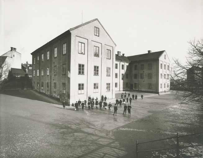 EN TREDJE VÅNING BYGGDES PÅ I SAMBAND MED OMBYGGNADEN TILL FOLKSKOLA PÅ 1860-TALET. BILDEN VISAR BARN PÅ SKOLGÅRDEN OMKRING SEKELSKIFTET 1900. FOTO: STOCKHOLMS STADSMUSEUM.