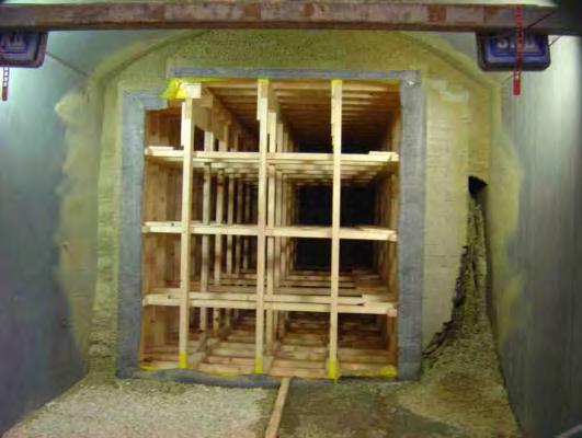 Figure 2.6 Photograph of a 1/2-scale backfilling test performed at the Äspö hard rock laboratory showing backfill erosion caused by water inflow and movement in channels or pipes (from Dixon et al.