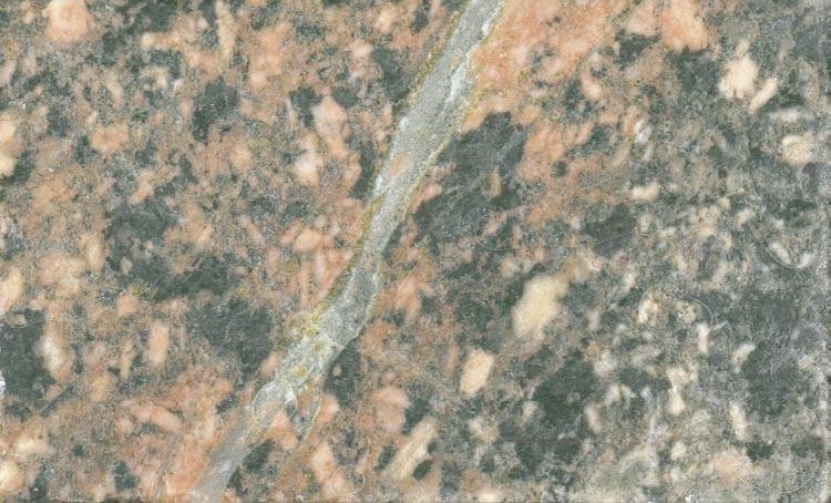 Saussuritisation of plagioclase crystals is widespread in the wall rock. Alteration of K-feldspar has also been observed but this alteration has not been as extensive as the alteration of plagioclase.