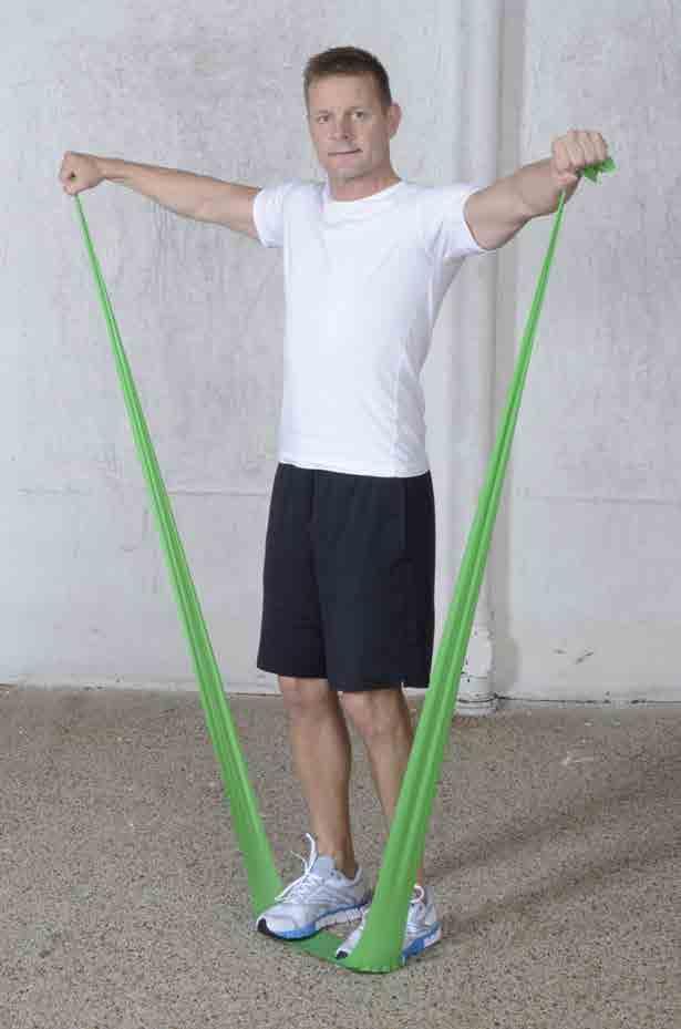 Eng: Shoulder lift sideways Trains shoulder muscles. Grasp the ends of the Pilates band and place the feet in the middle of the band.