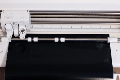 Tip: Curl up the vinyl s front edge a little so it doesn t snag in the roll feeder s cutting groove and so it s easy to push up against the machine s rollers.