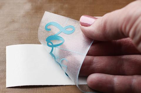Now press it down on your surface. Flat, smooth surfaces are the easiest to apply vinyl to. Cut your transfer tape so it s larger than the vinyl design.