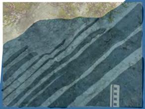 structure clearly defined against the thin dark blue beds