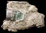 Andalusit är ett pelarliknande mineral med nästan kvadratiskt tvärsnitt. Mineralet är ogenomskinligt, även om det kan finnas undantag, och har olika färgnyanser, mest rödaktigt grå. Hårdheten är 7,5.
