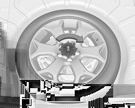 256 Bilvård Att ta bort: 1. Öppna golvluckan. 2. Reservhjulet låses med en vingmutter. Vrid vingmuttern motsols och ta bort reservhjulet. Under reservhjulet ligger bilens verktygslåda. 3.