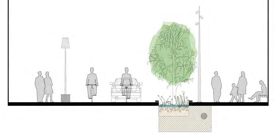 Gångytorna av släta betongplattor som ramas in av sju rader svart smågatsten mot parkering och fasad.