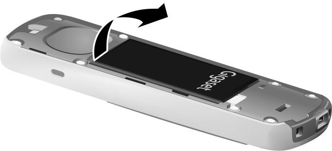 b a Placera batterilocket så att spetsarna i sidan ligger parallellt med hålen på höljets insida.