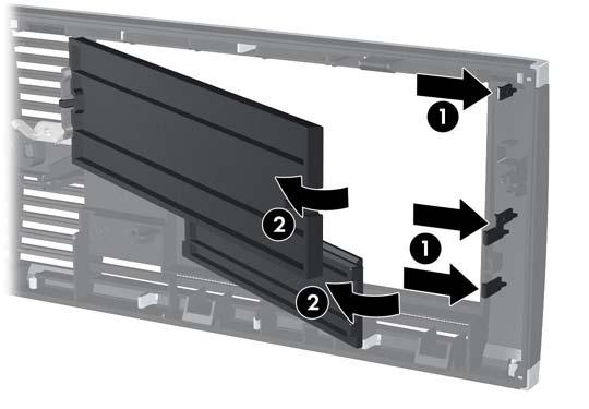 2. Du tar bort panelskyddet genom att trycka de två flikarna som håller det på plats mot ramens högra ytterkant (1).