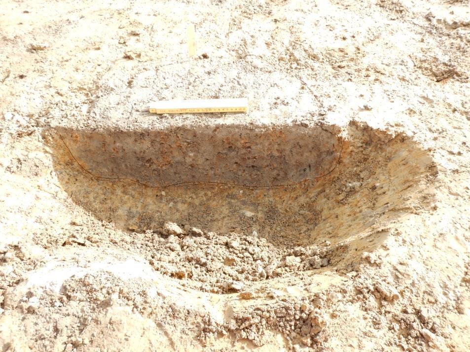 Fyllningen bestod av gråsvart sandig silt med inslag av träkol. Inga fynd påträffades i fyllningen. Gropens djup var 0,12 m. Figur 14.