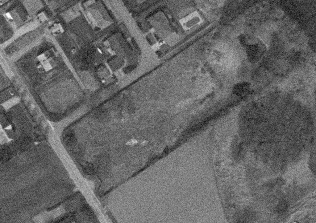 Figur 8 Flygfoto från 1984. Inga byggnader finns kvar på fastigheten. I nordöstra delen ses dammen.