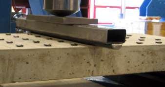 3 Figur 3.2. Fritt hängande betongplatta, storlek 70 340 1050 mm, med längsgående armering av 3 ϕ8 mm. Till vänster ses en apparat som kan skaka plattan.