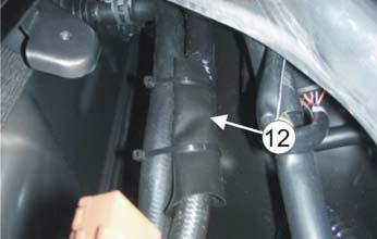 The free pipe stub pointing to the right. Split the tube () holding the hoses together. Note! Do not cut into the hoses. Cut the hose () in two places ().