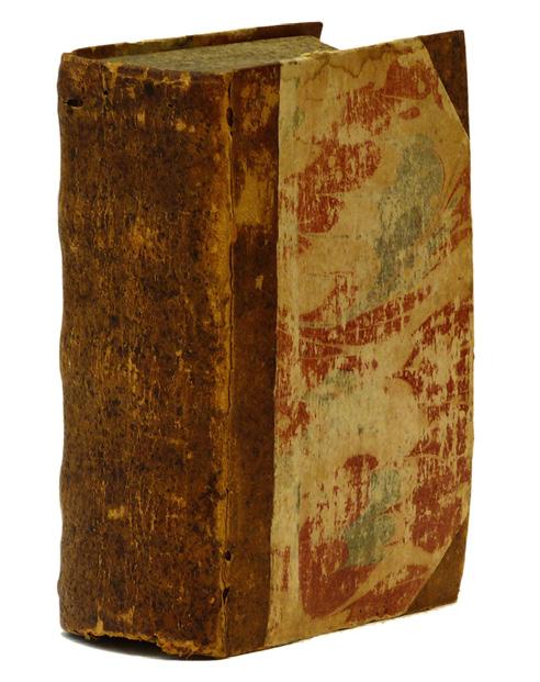 Somewhat worn half calf from mid 17thcentury, spine with raised bands, marbled boards and edges. Small worm holes in front hinge and on spine.
