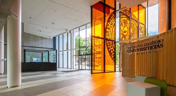A grand orange stained glass structure with an historical stamp is positioned like a half open door, white plaster street elevation vibrates with rhythm of terrazzo elements.