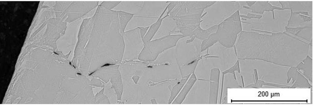 1 had an area of cold deformation near the surface, but also present were pores which appeared to be aligned along the grain boundaries.
