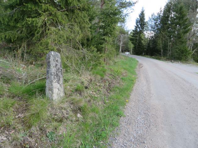 En väghållningssten intill byvägen mot