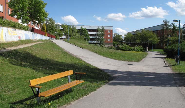 Parken kantas på sin övre nivå av en målad betongmur. En oval grusplan med två fotbollsmål ligger i parkens nedre del, omgärdad av staket och en syrénhäck.