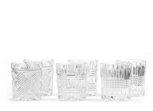 Crystal Pitcher Kanna i vackert mönstrat kristallglas som fångar och sprider ett vackert ljussken från andra ljuskällor.