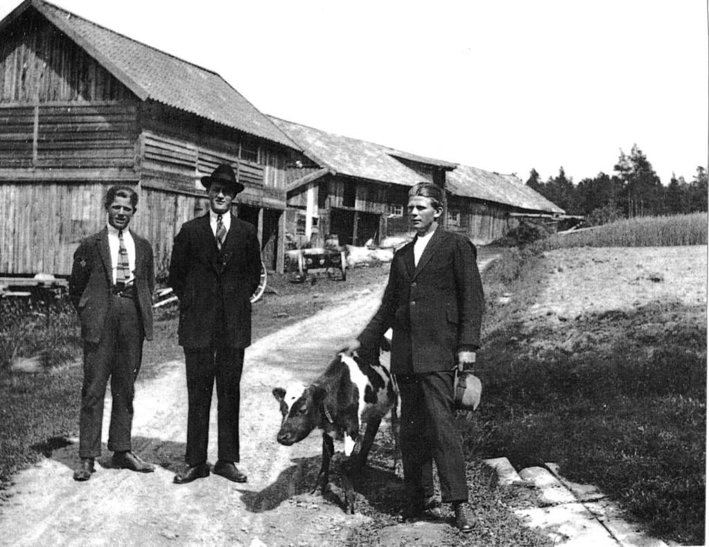 Fotografi från slutet av 1910-talet eller början av 1920-talet. Tutviks ekonomibyggnader från väster. De tre eleganta männen är Augusts och Emmas söner.
