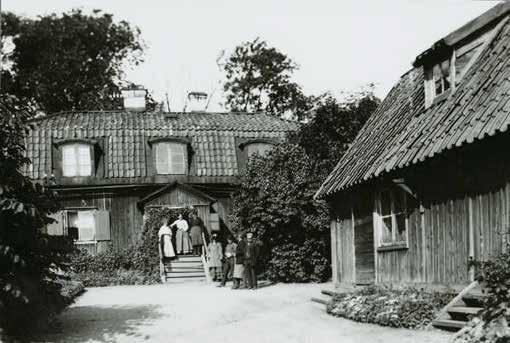 BILD TAGEN ÅR 1907 ÖVER BOSTADSHUSET MED TRÄDGÅRD OCH UTHUS. PÅ TRAPPAN STÅR TRÄDGÅRDSMÄSTAREN KJELLBERG SOM ARRENDERADE TOMTEN.