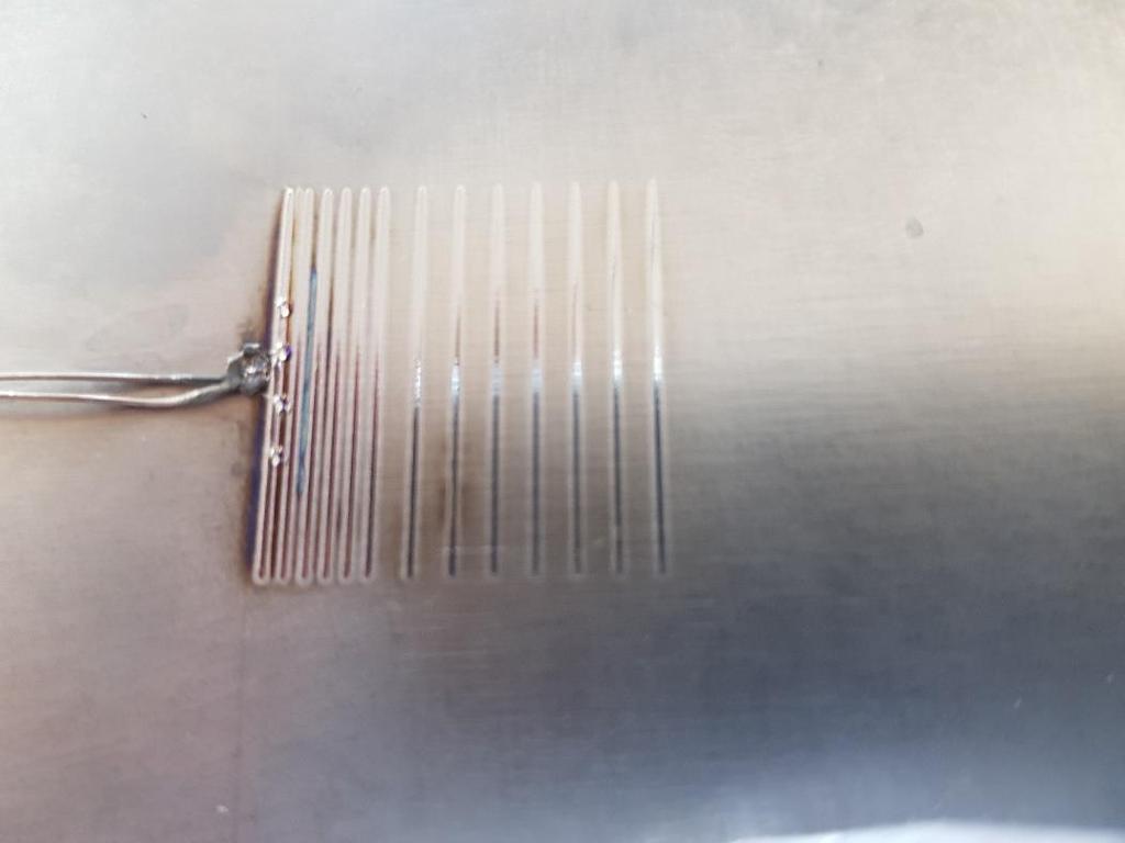Figure 33 Test plate with attached thermocouple showing weld lines at 20, 18, 16, 14, 12, 10, 8, 6, 5, 4, 3, 2, 1,5, & 1 mm distance from the thermocouple.