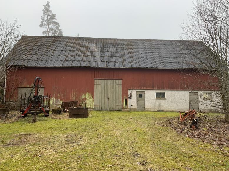 219-3-22 7(11) EKONOMIBYGGNADER Ladugård Äldre konventionell högbyggd ladugårdsbyggnad om ca 215 kvm under eternittak. Murad stalldel, i övrigt trästomme.