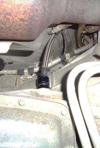 If hot (expanded) fluid begins to run out of the port, reinstall the cap, start the vehicle and run it